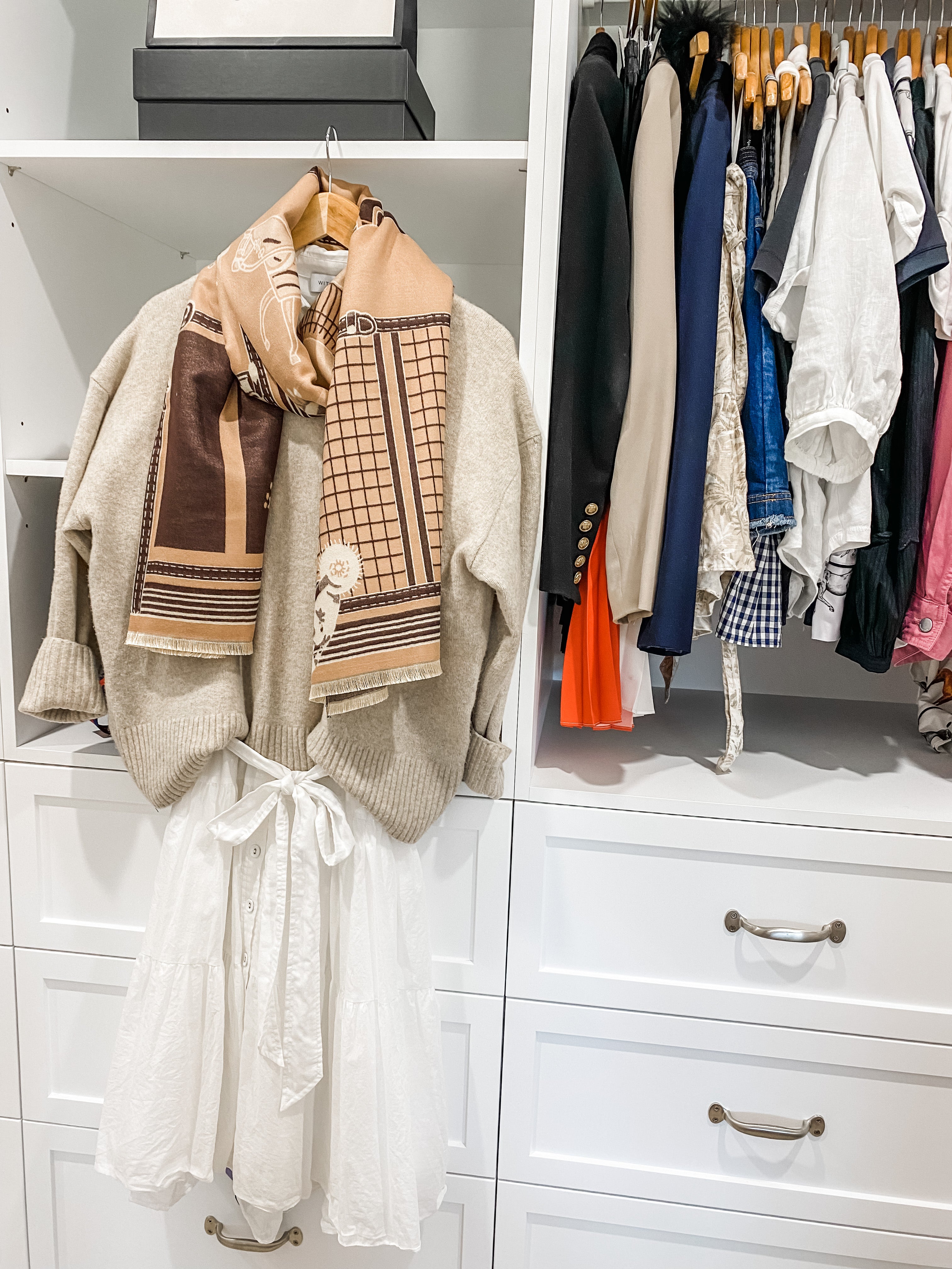 Beige Scarf shown with cream jumper hanging in robe.